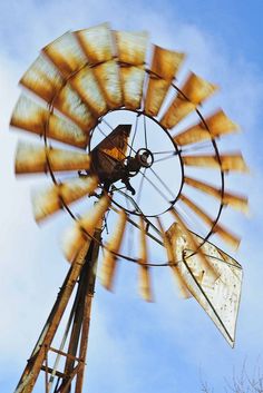 an old fashioned windmill spinning in the wind