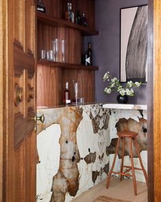 a bar with marble counter tops and wooden stools