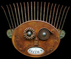 an old rusty comb with metal parts on it's face and thermometer in its mouth