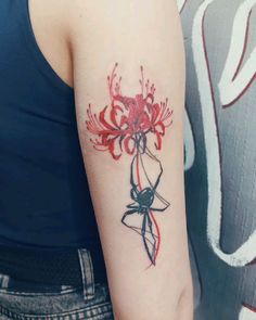 a woman's arm with a red flower tattoo on the left side of her arm