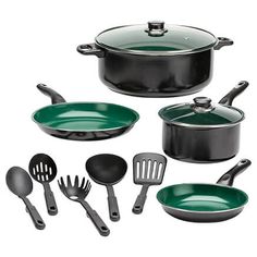 an assortment of green pots and pans with utensils in them on a white background