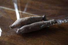 some type of root sitting on top of a wooden table with clear plastic wrap around it