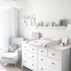 a baby's room with white furniture and decorations