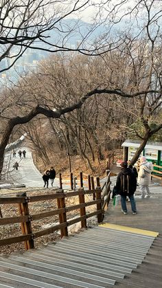 people are walking up and down stairs in the park with cows on the other side