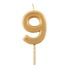 the number nine candle is gold on a stick