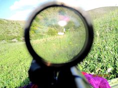 a view through a magnifying glass looking at a field