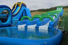 an inflatable water slide with several slides