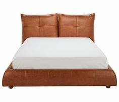 a brown leather bed frame with white sheets