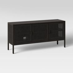 the sideboard is made from black wicker and has two doors on each side