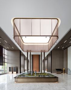 an empty lobby with marble flooring and large skylight above the entrance to it