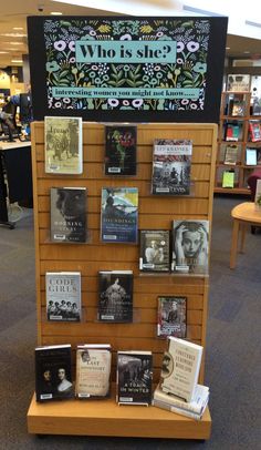 there is a display in the library with books on it and an advertisement for who is she?