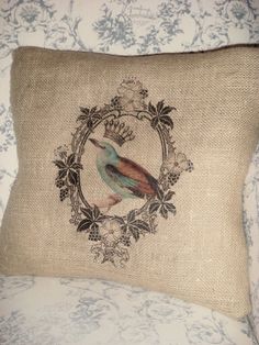 a decorative pillow with a bird on it