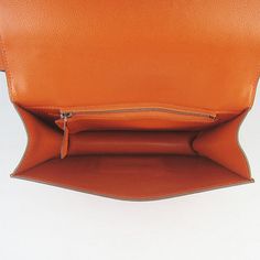 The material is a beautiful leather which is very chic and durable.The color on this bag is complemented with palladium (Silver-toned) or goldtone hardware.This is THE bag for the Hermes connoisseur.The bag is opened and closed using the magnetic closure in the front - letter 'H'.The interior is lined with soft evercalf leather and features 2 compartments.Each compartment has a side pocket. The exterior also features a side pocket.This is a VERY VERY understated bag. Definitely classic and can b Modern Cognac Satchel With Palladium Hardware, Classic Orange Shoulder Bag With Detachable Strap, Cognac Bag With Silver-tone Hardware And Top Handle, Luxury Cognac Shoulder Bag With Silver-tone Hardware, Cognac Shoulder Bag With Silver-tone Hardware, Cognac Top Handle Bag With Silver-tone Hardware, Formal Cognac Shoulder Bag With Silver-tone Hardware, Classic Orange Top Handle Satchel, Orange Office Satchel With Detachable Strap