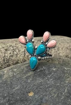 Signed Navajo Sterling Silver Turquoise Pink Conch Shell Multi Stone Cactus Ring 7.25 Orders totaling $100 and up include an anti-tarnish treated velvet jewelry pouch!  Ring is a size 7.25 Face of ring measures approximately 1.25" X 1.5" Weighs approximately 10 grams Condition: New Metal: Sterling Silver See photos for hallmark Comes in a gift box  This item is in used condition and will exhibit the expected surface scratches and dings to the silver from normal wear.  Take a look at our other ri Conch Ring, Stone Cactus, Cactus Ring, Western Clothes, Turquoise Jewelry Native American, Navajo Rings, Velvet Jewelry, New Metal, Conch Shell