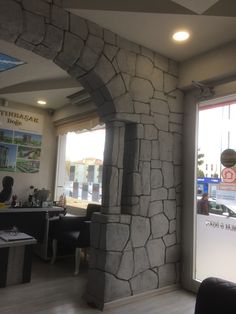 the interior of a restaurant with stone walls and wood flooring is shown in front of an open window