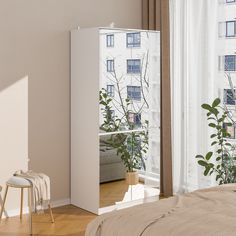 a bedroom scene with focus on the bed and mirror cabinet in the foreground, there is a window to the outside