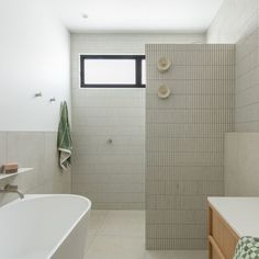 a bathroom with a white bath tub sitting next to a walk in shower and sink