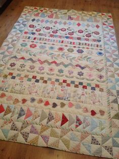 an old quilt is laying on the floor