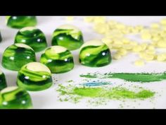 some green and white marbles on a table