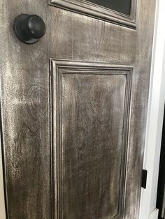 the front door is painted silver and has a black handle on it's side