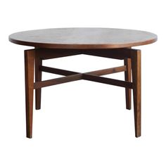 an oval table with wooden legs on a white background