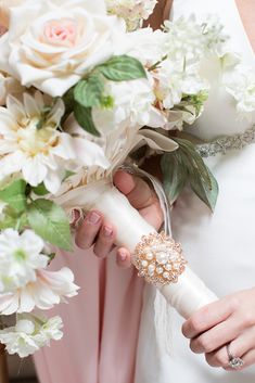 the bride is holding her bouquet in her hand