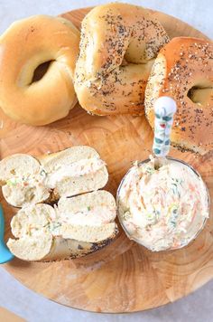 bagels and dip on a wooden plate