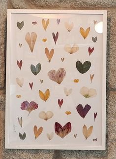 a white frame with many different colored hearts on it