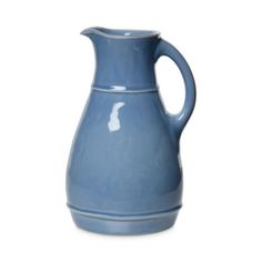 a blue ceramic pitcher on a white background