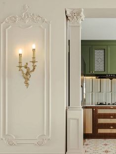 an ornately decorated kitchen with green cabinets and white pillars in the doorway to the dining room