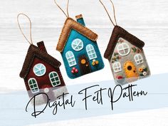 three felt houses hanging from strings on a white wooden background with the words digital felt pattern