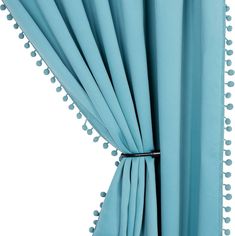 a blue curtain with pom poms on it