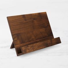 a wooden cutting board sitting on top of a white counter