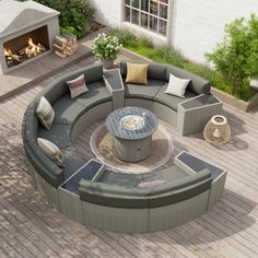 a fire pit sitting on top of a wooden floor next to a patio with lots of furniture