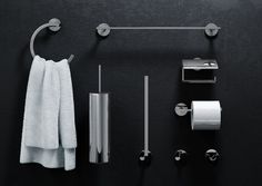 the bathroom accessories are neatly arranged on the black surface, including towels and toilet paper