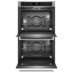 two ovens side by side with the door open and one showing its electronic controls