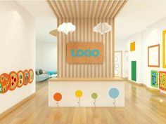 the interior of a children's playroom with wooden floors and colorful artwork on the wall