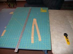 the cutting mat is being used to make a diy notebook cover with paper and scissors