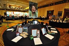 a round table covered in black cloths with pictures on it