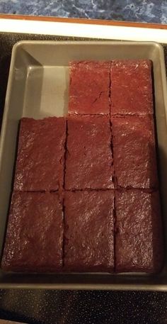 a pan filled with brownies sitting on top of a counter