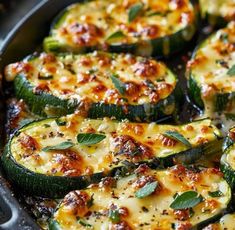 baked zucchini with cheese and herbs in a skillet ready to be eaten