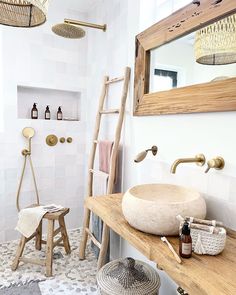 a bathroom with a sink, mirror and ladder in the shower area next to it