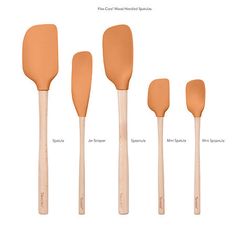 four wooden spatulas labeled in different shapes and sizes