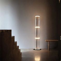 a tall glass lamp sitting in the middle of a room