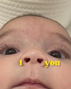 a close up of a baby's face with the words i you on it