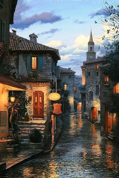 a painting of a cobblestone street at night with buildings lit up by lanterns