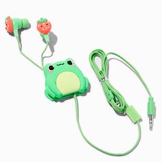 a green frog earbud and headphones on a white background