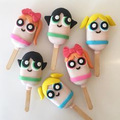 six lollipops with cartoon characters on them sitting on top of each other