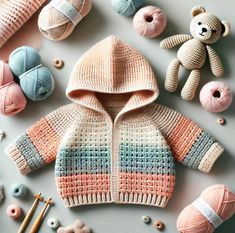 a baby's knitted jacket and sweater surrounded by crochet balls, yarns and knitting needles