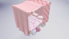 a small bed with pink sheets and pillows on it's sides, next to a pillow